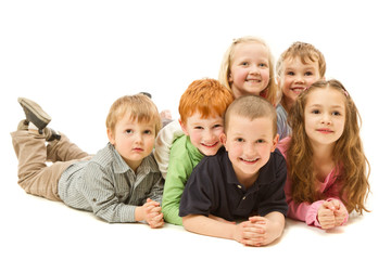 Group of happy kids laying on floor together
