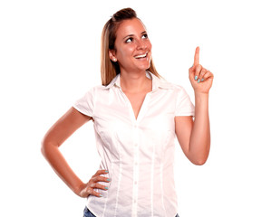 Smiling young woman looking and pointing up