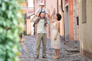 Happy young family in city street