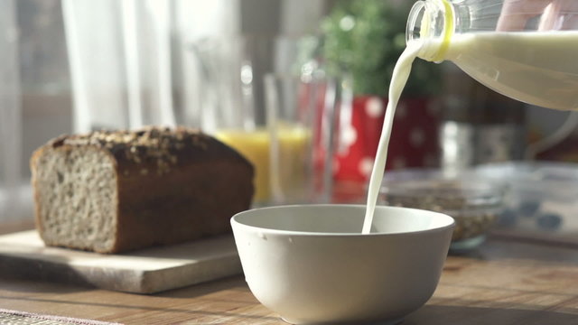 Pouring milk into bowl, slow motion shot at 240fps
