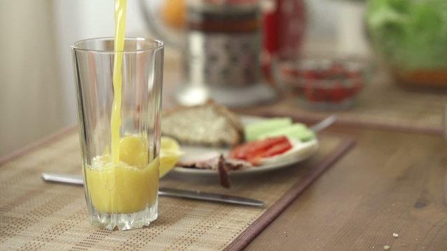 Pouring orange juice in glass
