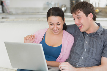 Two people having fun with the laptop