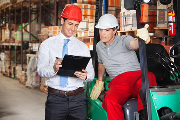 Supervisor Showing Clipboard To Foreman