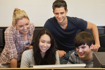 Fototapeta premium Students sitting standing looking at computer