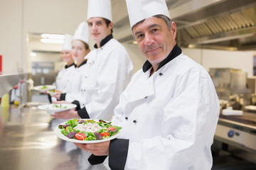 Cheerful Chef's showing their salads