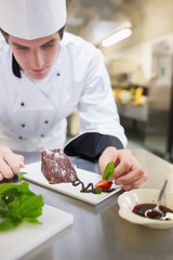 Chef putting mint on the desert plate