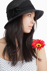 Woman with flower looking away