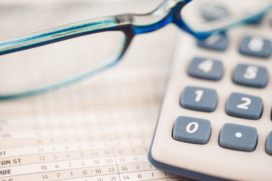 Close-up of glasses and calculator