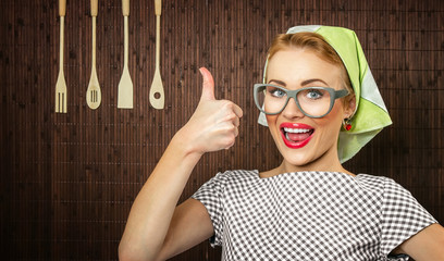 Happy woman cook with thumbs up holding salad