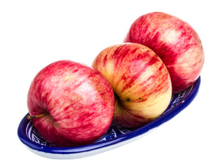 fresh red apples in the dish isolated on white background
