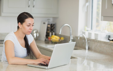 Fototapeta premium Woman sitting in the kitchen