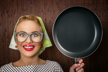 Close-up funny woman cook with pan - vintage concept