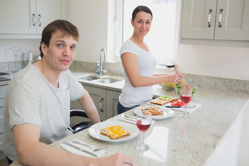 Obraz na płótnie Canvas Happy couple having lunch in kitchen