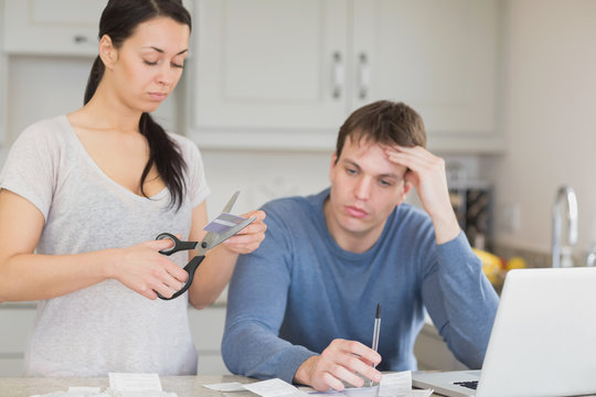 Woman Cutting Through A Credit Card