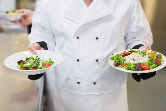 Chef holding two salads