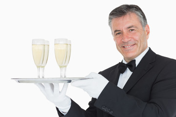 Waiter holding tray with glasses full of champagne