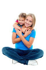 Cute daughter hugging her mother from behind