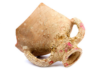 Piece of broken ancient mug with fossils isolated on white backg