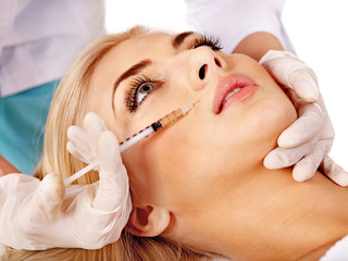 Doctor giving woman cosmetic injection