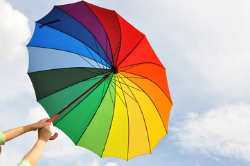 Rainbow umbrella in the hands - 46355888