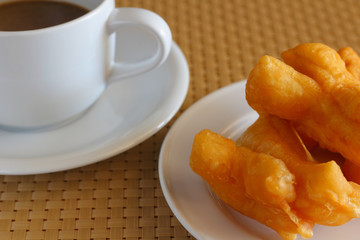 Deep-fried dough stick and coffee