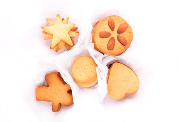 Christmas biscuits in white individual cases, isolated on white