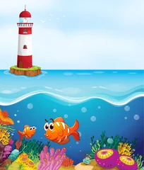  een vuurtoren, vissen en koraal in zee © GraphicsRF