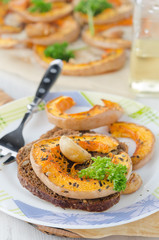 Baked pumpkin slices on pieces of corn bread