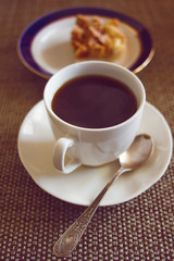 Coffee cup with cake on table