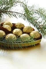 chocolate truffles in a gift box under the Christmas tree