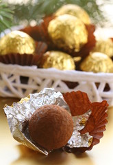 chocolate truffles in a gift box under the Christmas tree