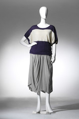 full-length female clothes on a mannequin in light background