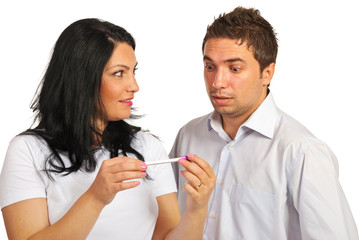 Surprised couple holding pregnancy test