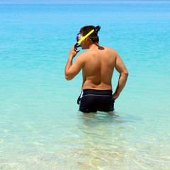 A man with a diving mask in the sea