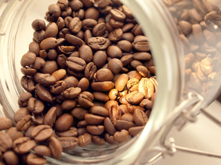 Heap of coffee beans from jar