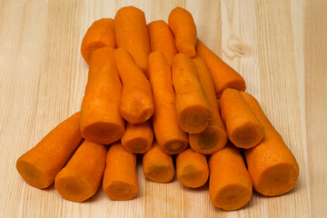 peeled carrots lying on a cutting board