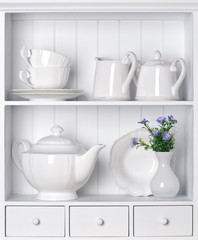 White shelf with vintage porcelain tableware