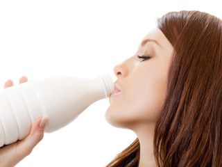 Beautiful woman drinking milk, over white