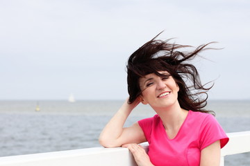 Fototapeta na wymiar Woman of which in face blows marine wind