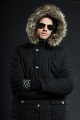 Fototapeta premium Handsome man dark winter fashion. Studio shot. Wearing glasses.