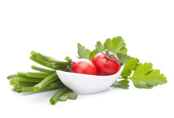 Spring onions and cherry tomato in bowl
