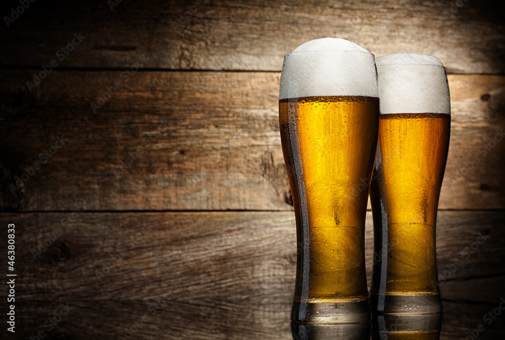 Wall mural two glass beer on wood background with copyspace