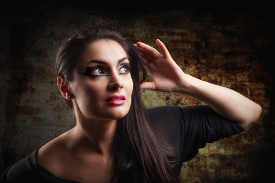 Seductive brunette  woman isolated on black background
