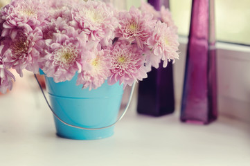 Fototapeta na wymiar beautiful delicate bouquet of pink chrysanthemums in a blue buck