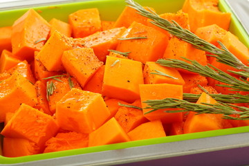 Slices of pumpkin in baking dish.