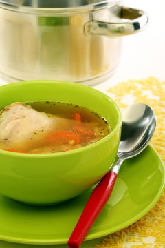 Chicken soup in a green bowl.