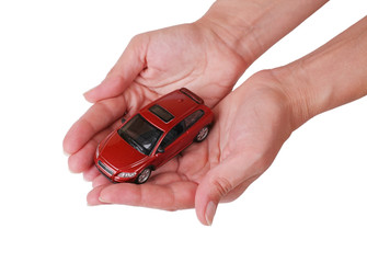 Small red toy the car in female hands