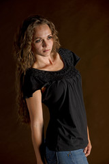 Smiling pretty woman with a brown background