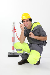 Worker in reflective work-wear using radio receiver