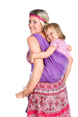 happy mother carrying a baby girl on her back in sling isolated